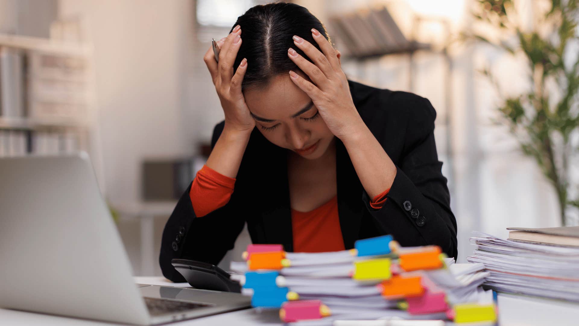 woman clutching her head at work as she thinks i'm not good at that