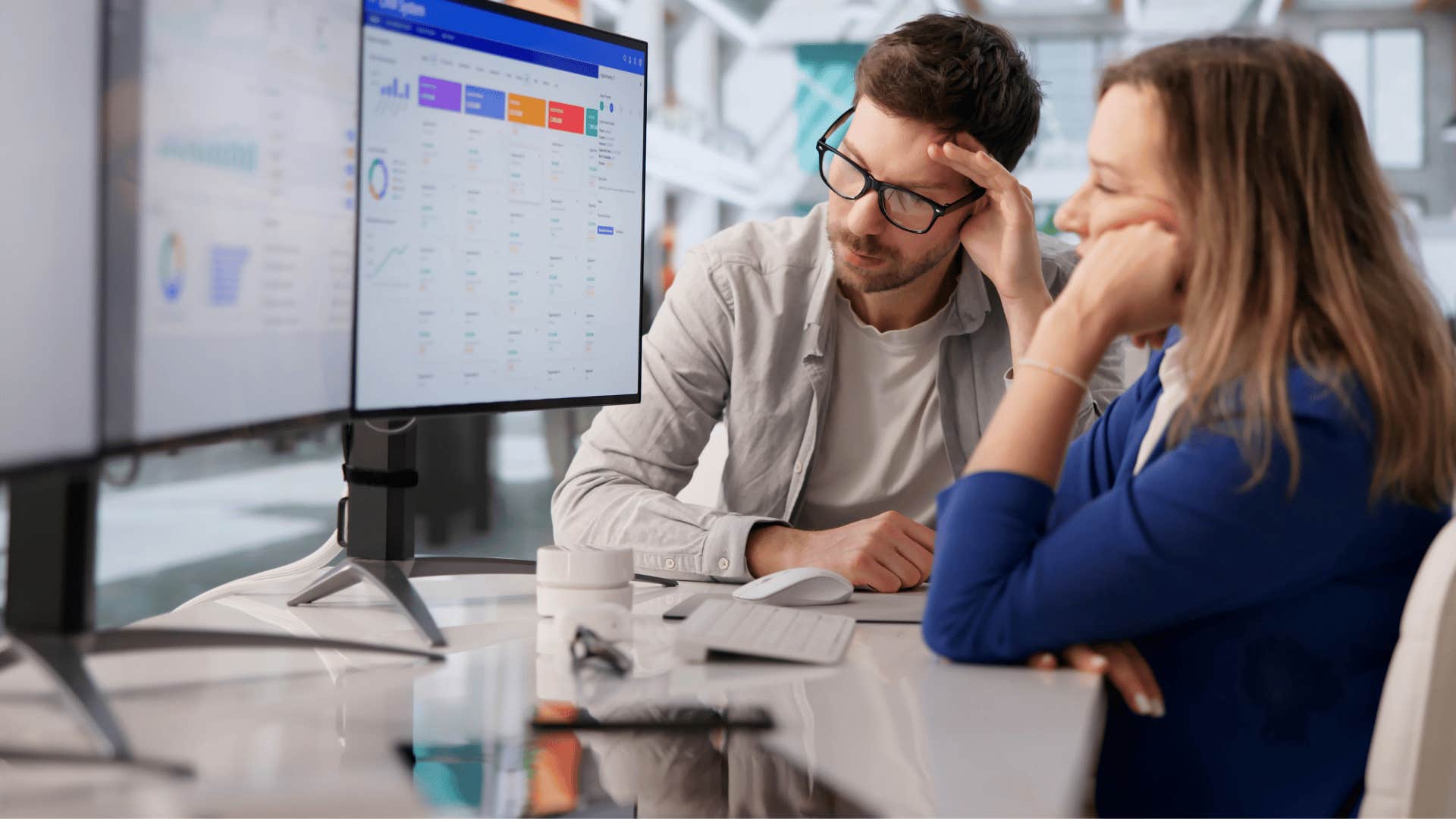man and woman staring at screen at work as they think that's too much work