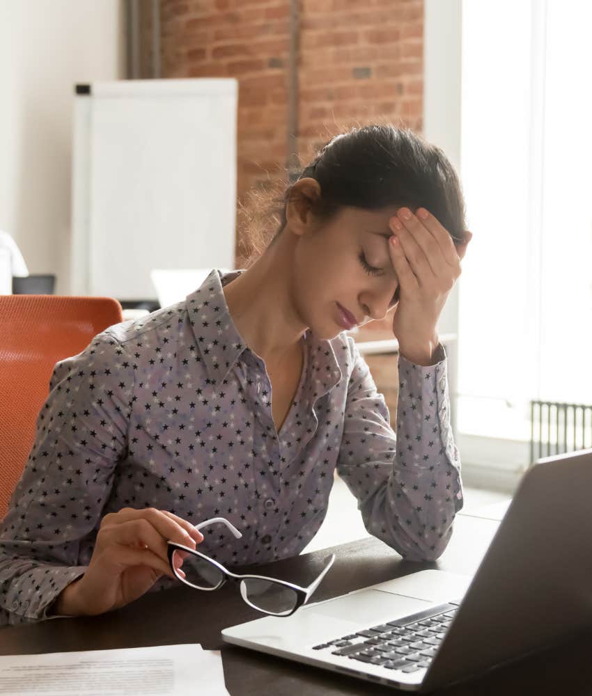 woman hiding her disappointment at her desk