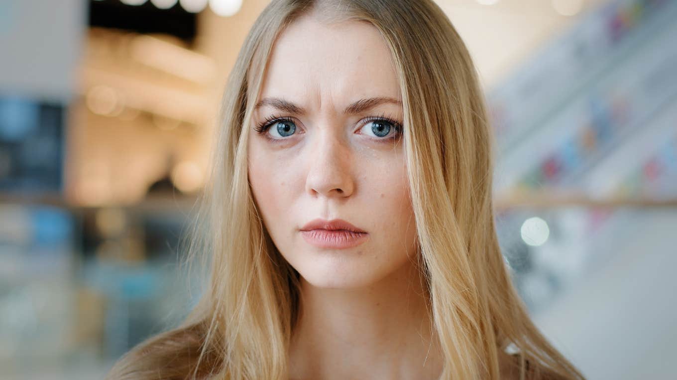 woman with a negative look on her face scowling slightly 