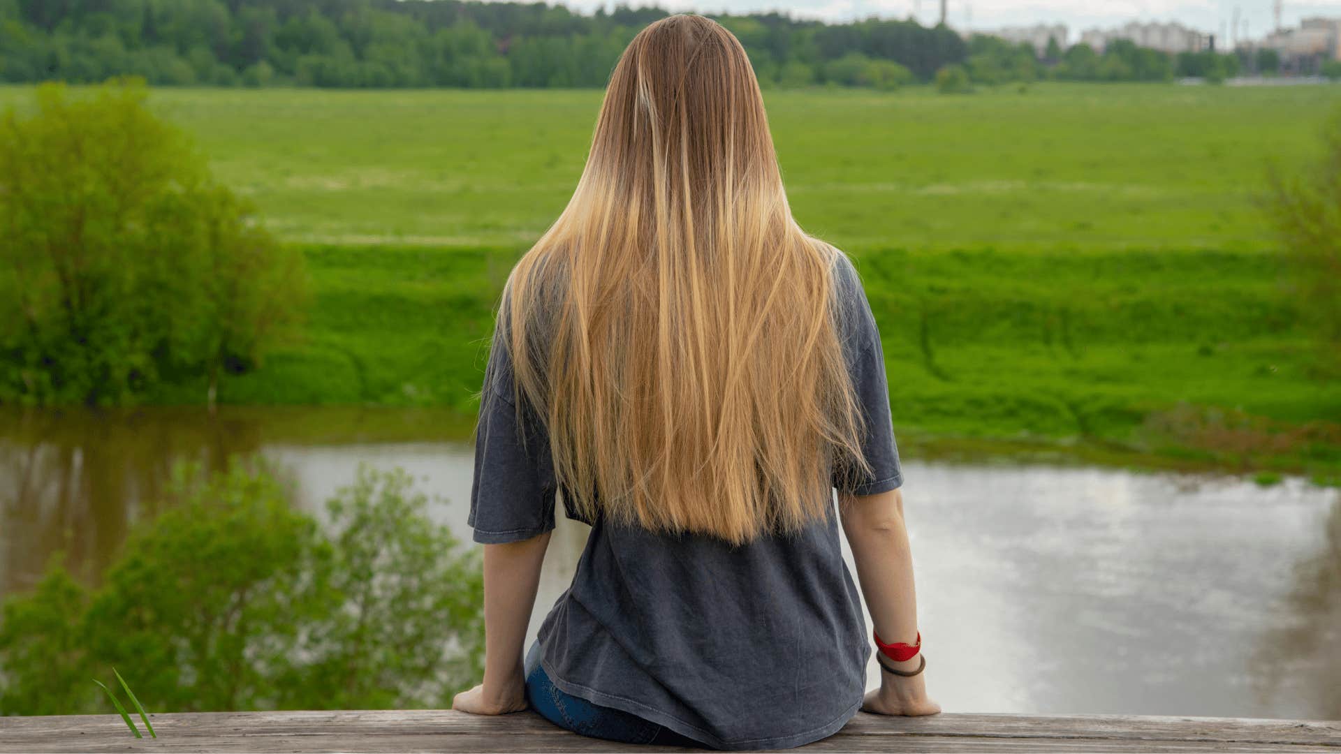 woman with blonde hair sitting and cloud watching