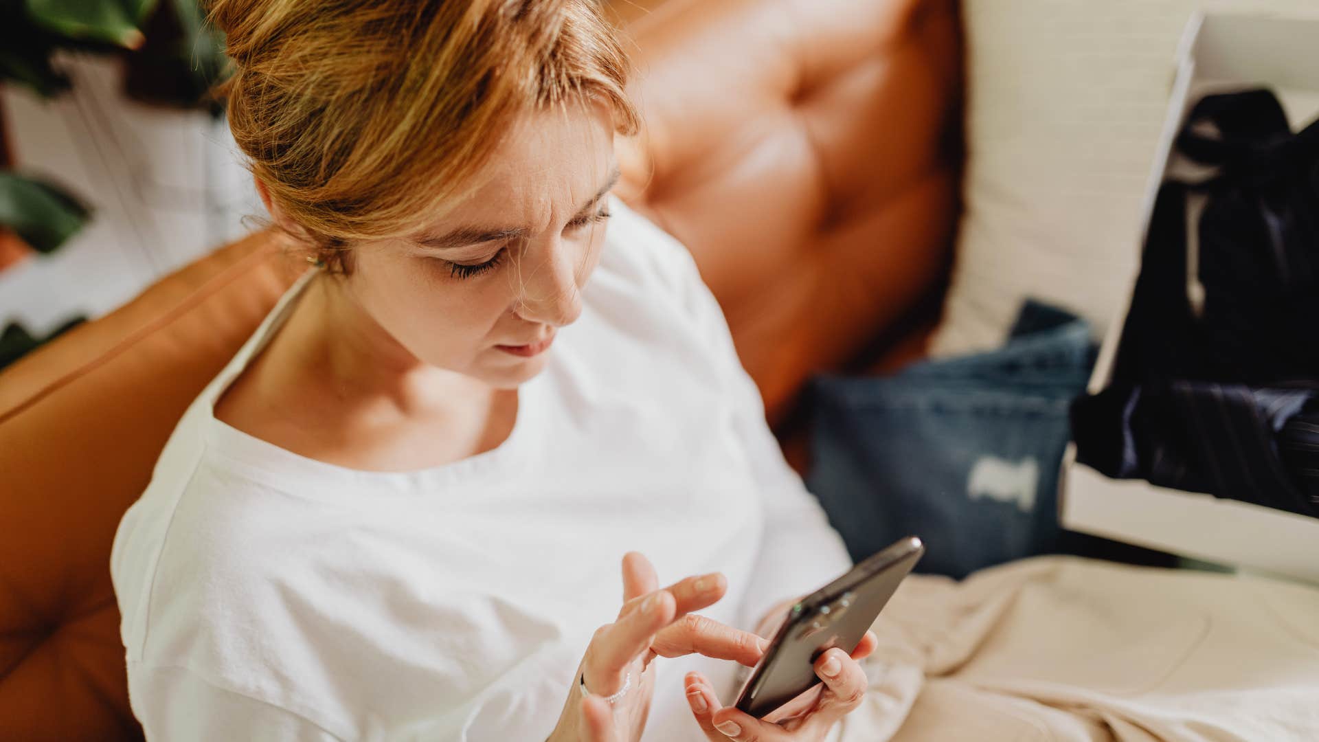 woman texting her friend that she's already in for the night