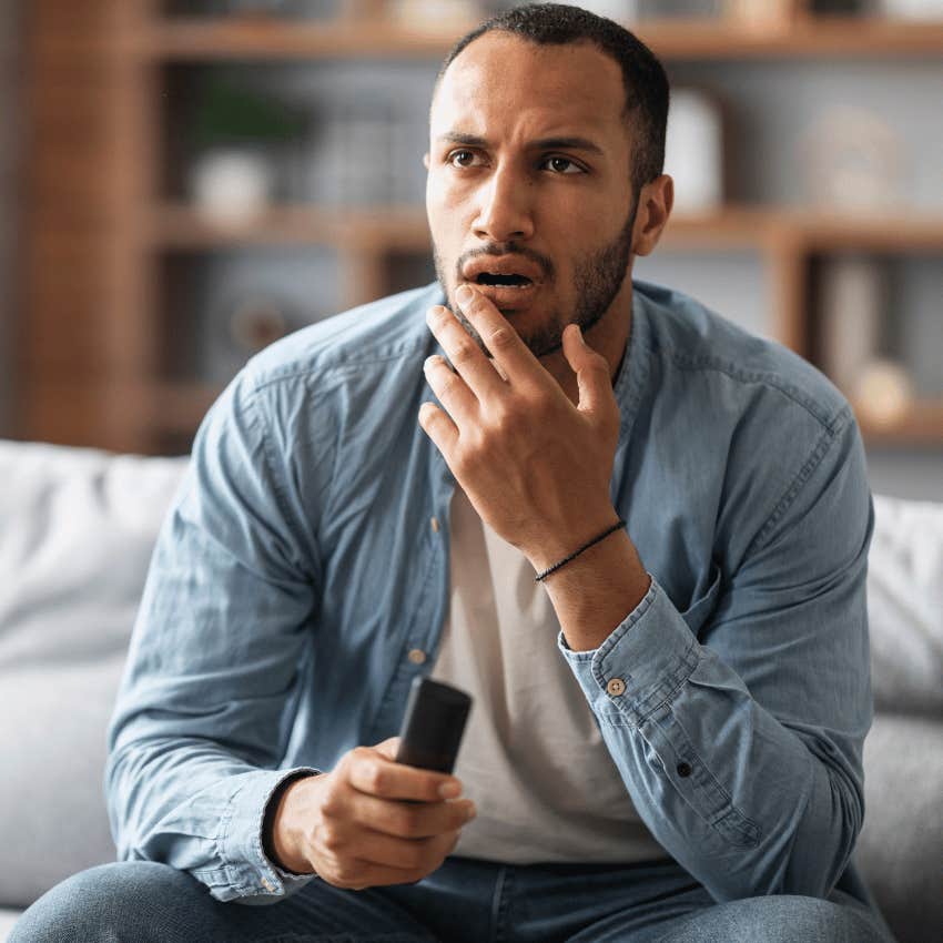 man breathing through his mouth watching tv