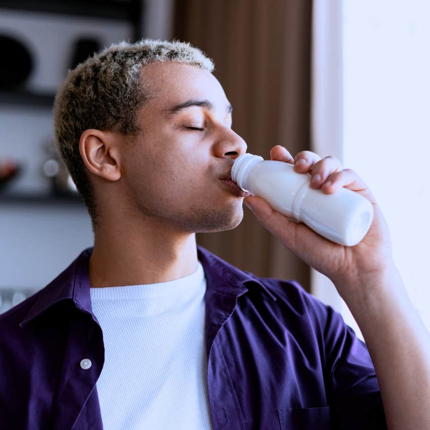 man with an extra pep in his step fueling himself with a beverage