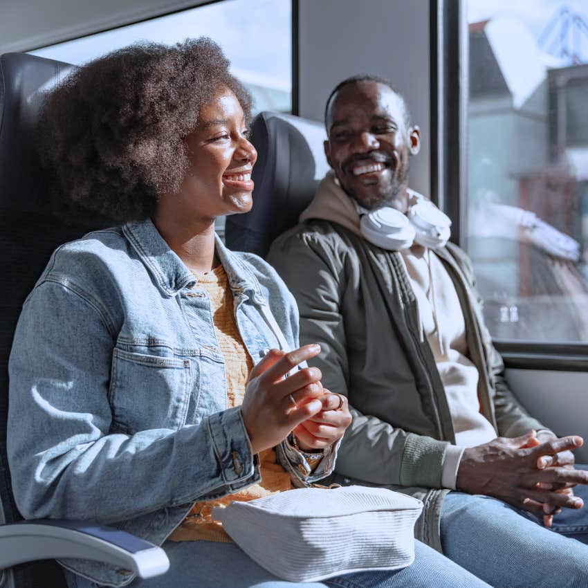 open-minded curious woman talking to stranger on a train