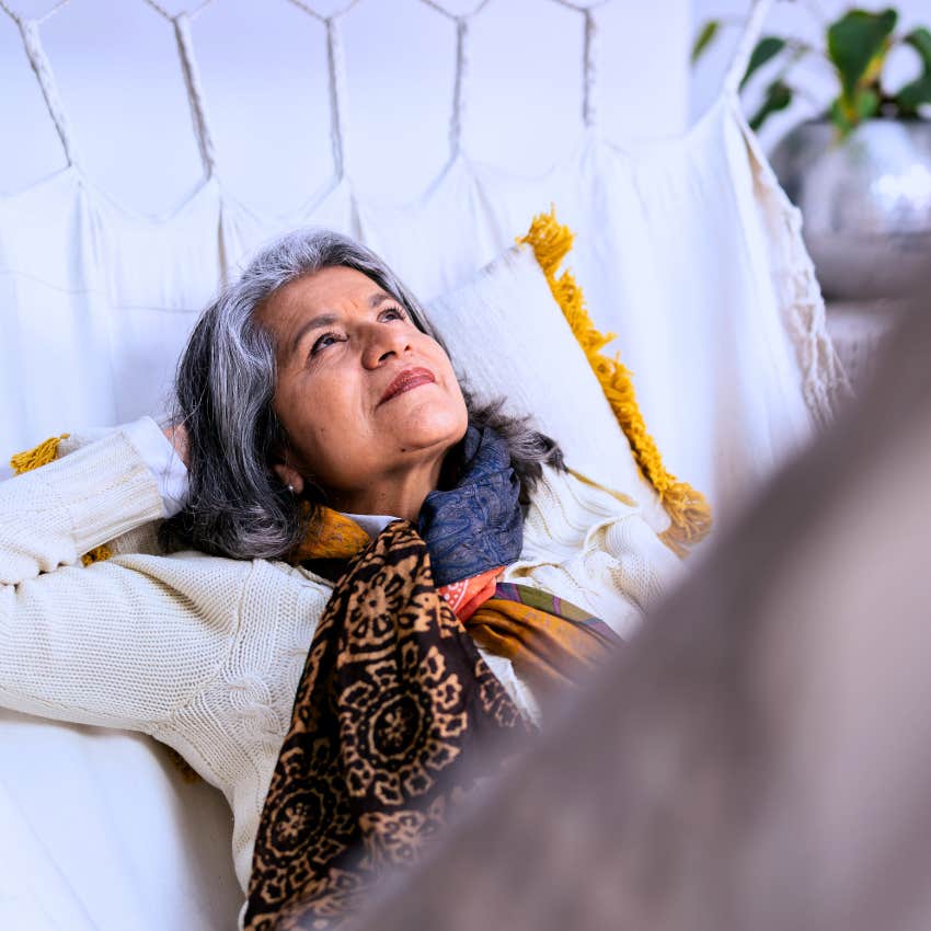 self-assured older woman sitting alone at home