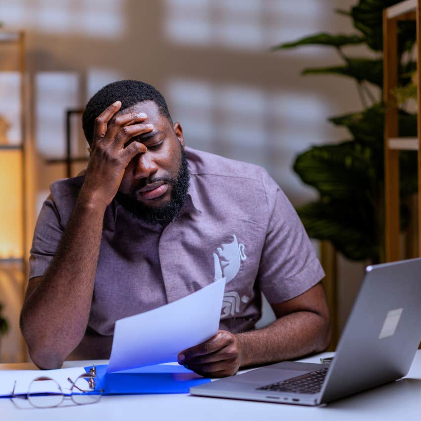 Distracted man dealing with financial stress or crisis at home.