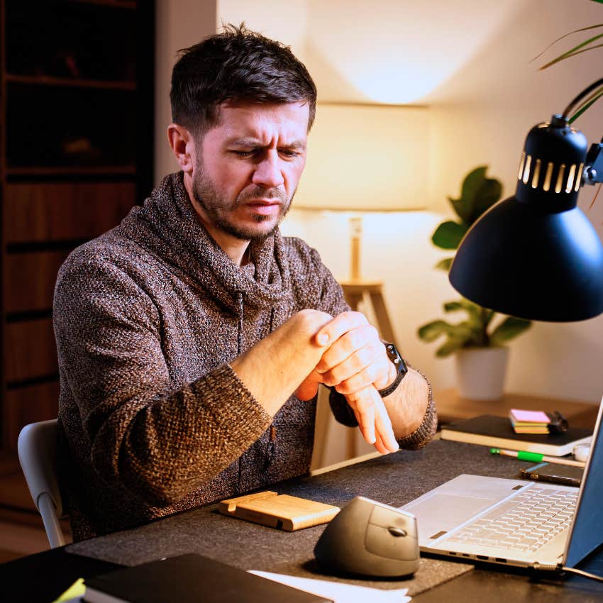 Man carrying tension constantly fidgeting at his desk.