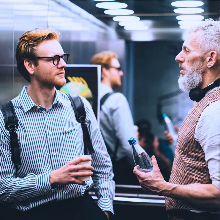 man who's not fake avoiding stranger on elevator