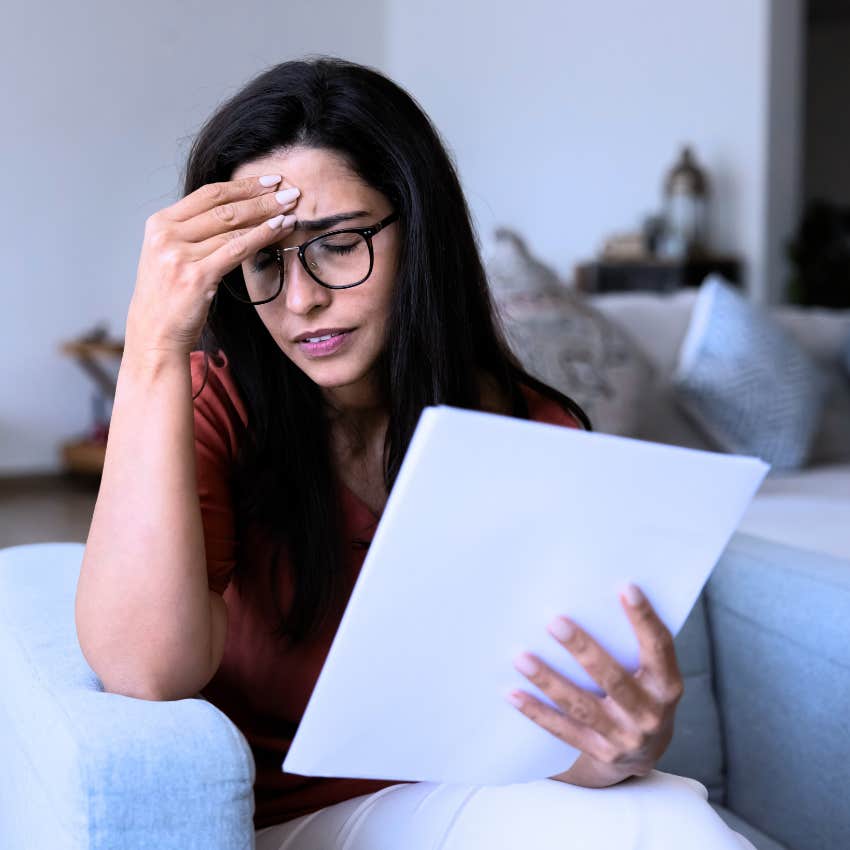 Woman who blames herself for feeling uncertain doing bills.