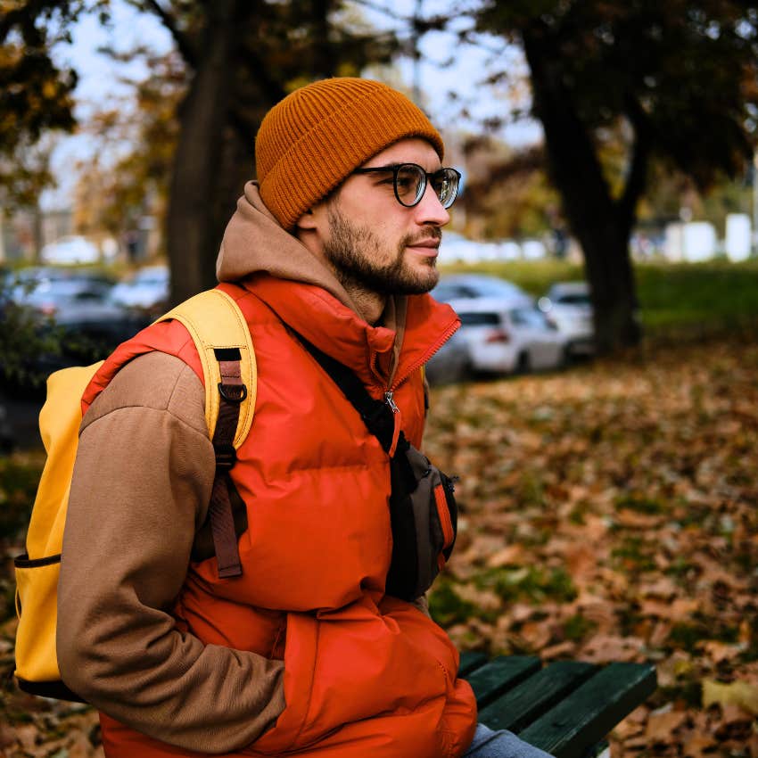 man wearing practical clothing sitting outside