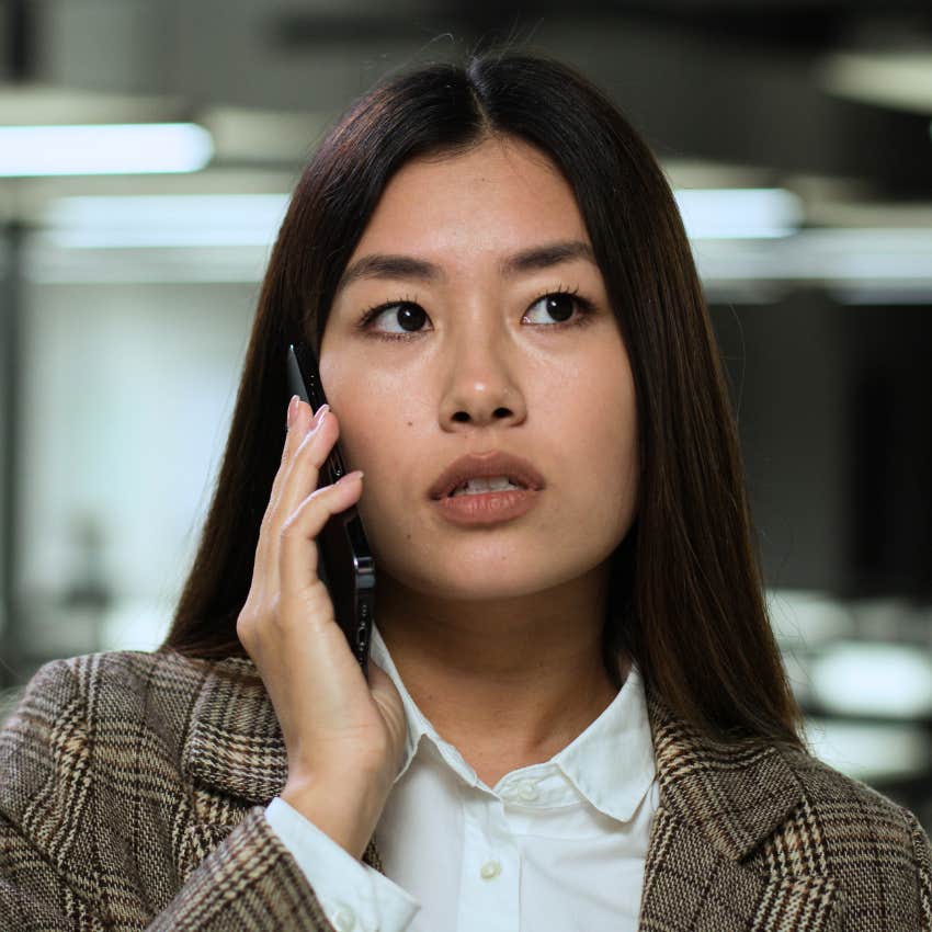 Woman dismissing their own achievements on the phone.