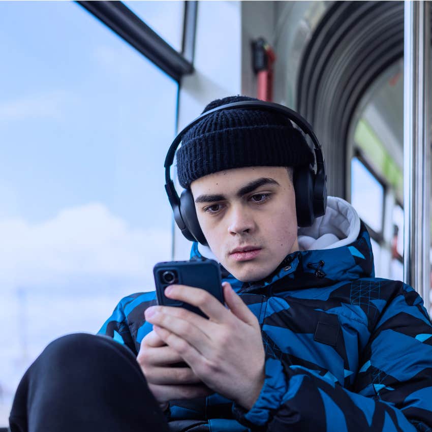 Man trying to be invisible by using his phone in public.