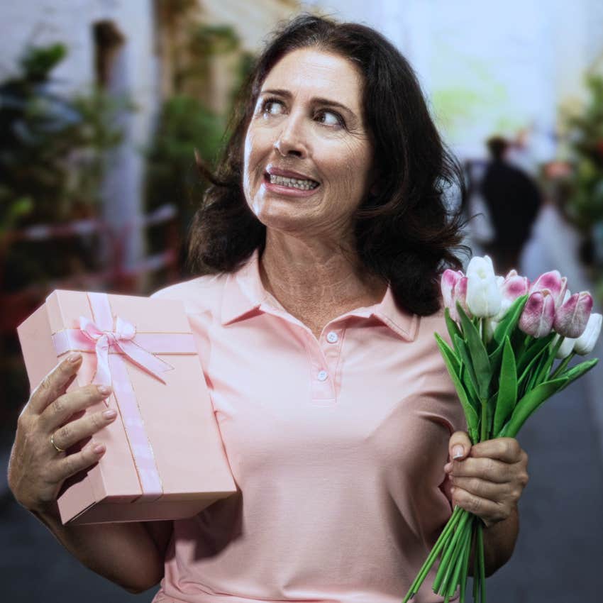 awkward woman who's used to being an observer walking with flowers
