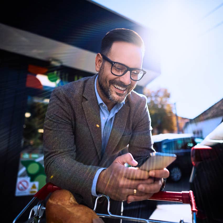 man who makes grocery shopping a ritual smiling with his cart