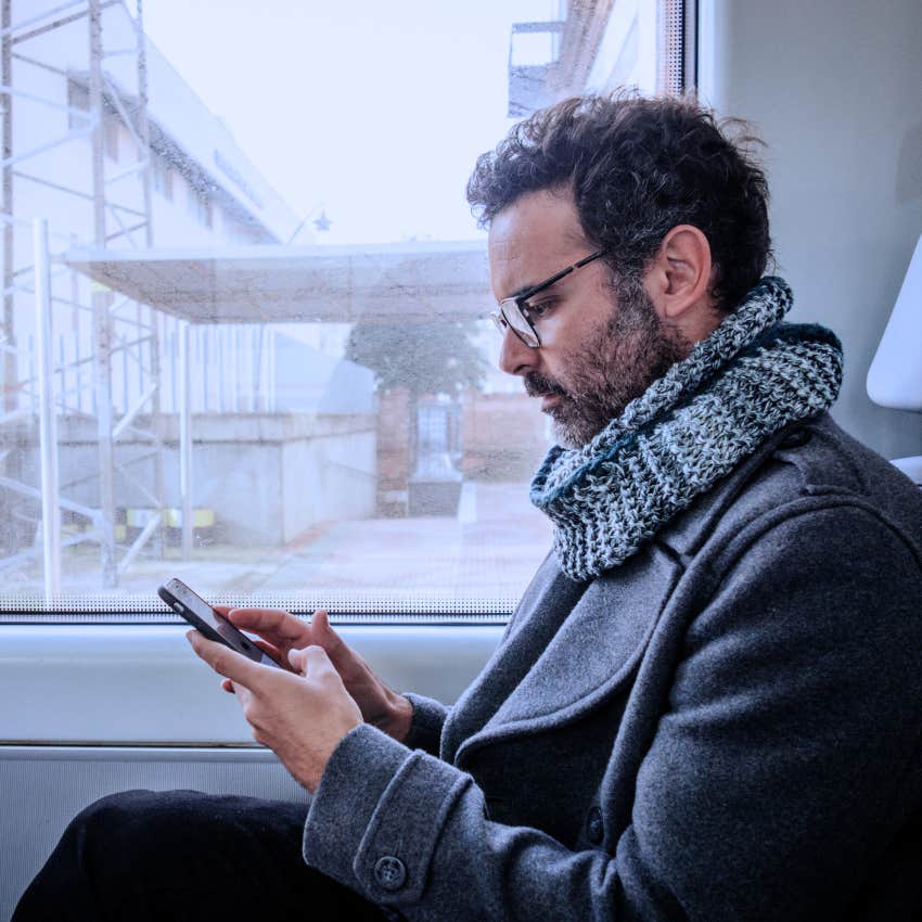 Man losing the energy to interact with strangers and looking at his phone.