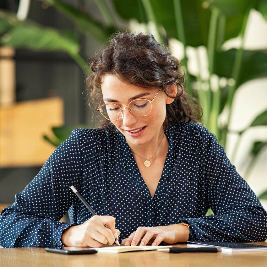 woman taking notes on paper