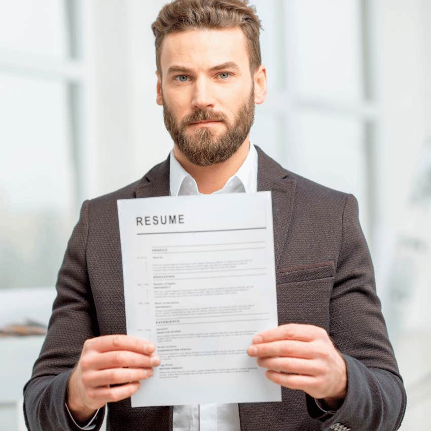 man holding up a scannable resume