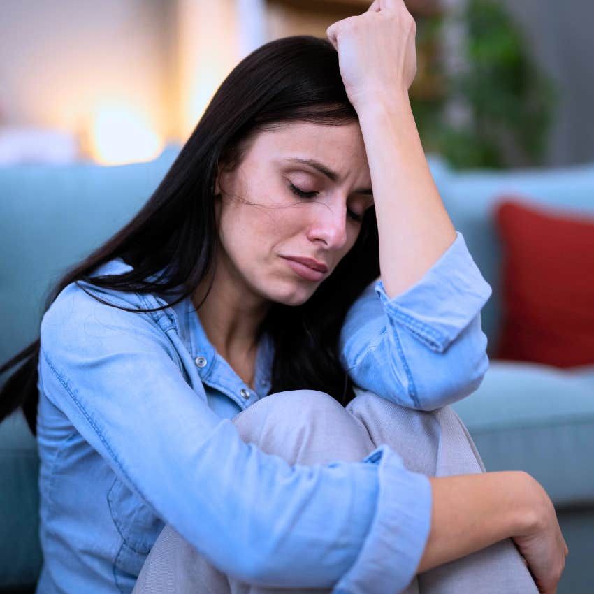 self-sacrificing woman looking upset at home alone