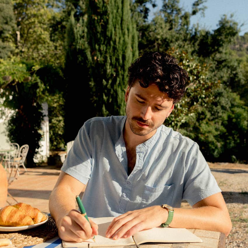 man with intuitive intelligence journaling