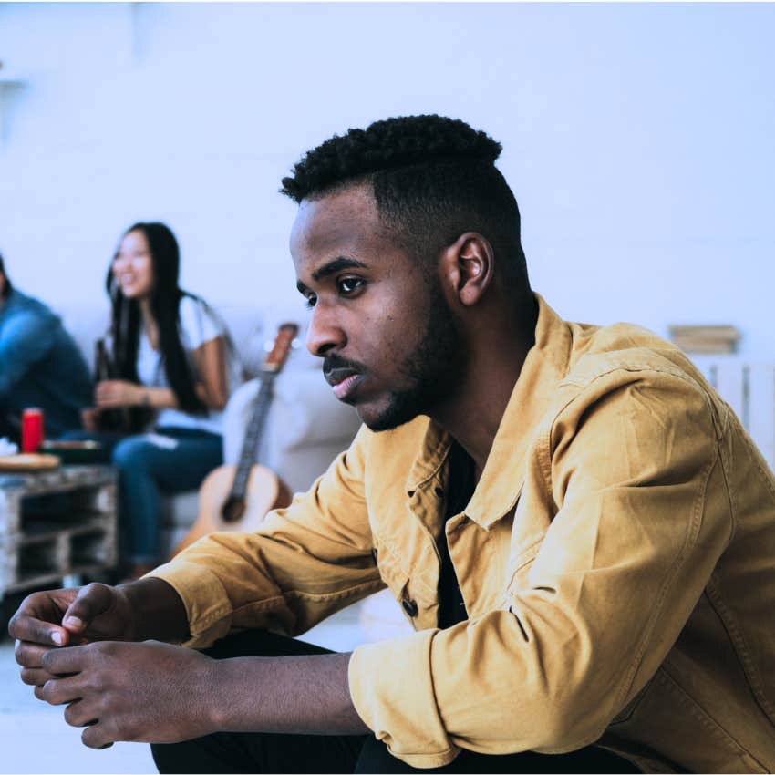 Anxious man saying "I don't know anyone" at a crowded party.