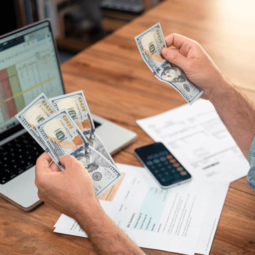 male hand counting physical money saving and retiring early