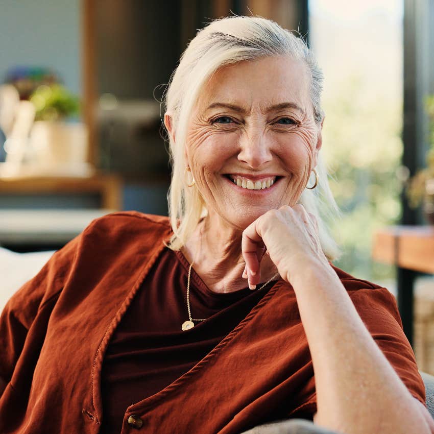 smiling woman who is less anxious because she has a bigger paycheck