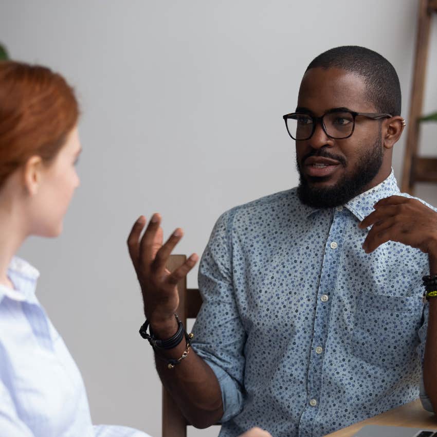 man feeling enlightened talking to colleague during work meeting