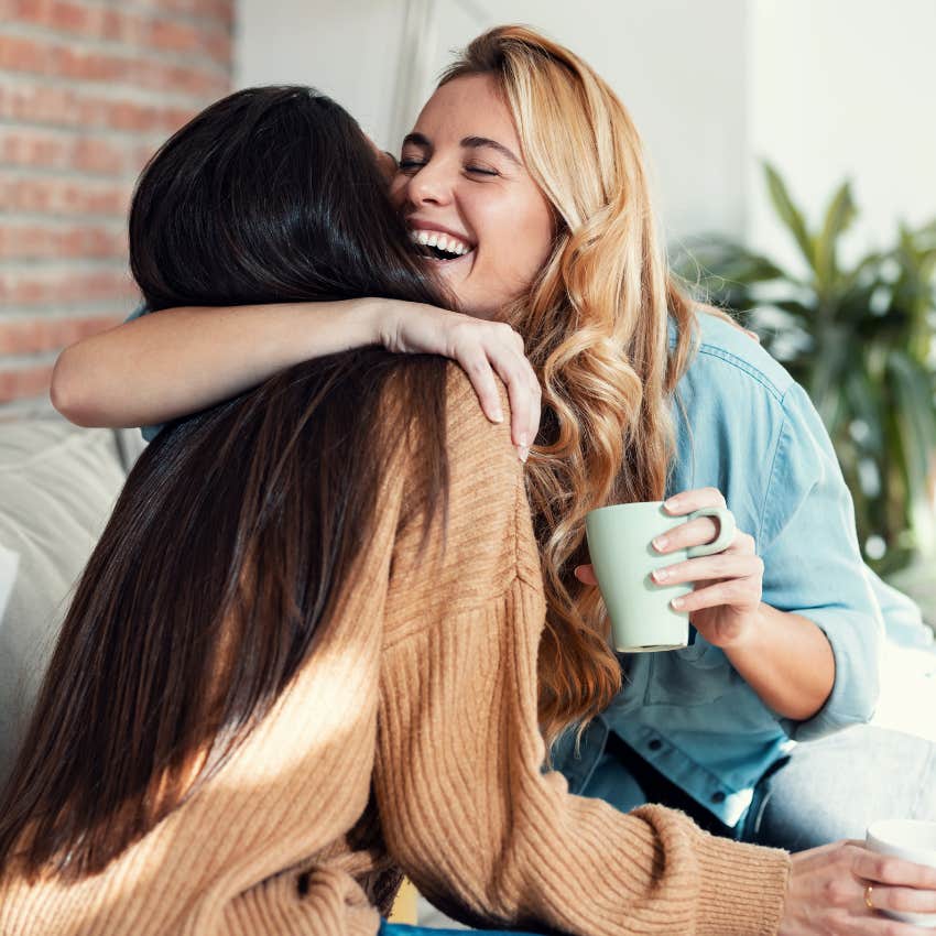 grateful woman hugging her friend thanking her