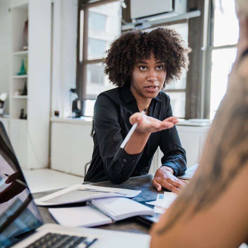 woman with low emotional IQ and lack of empathy aggressively setting boundary with colleague