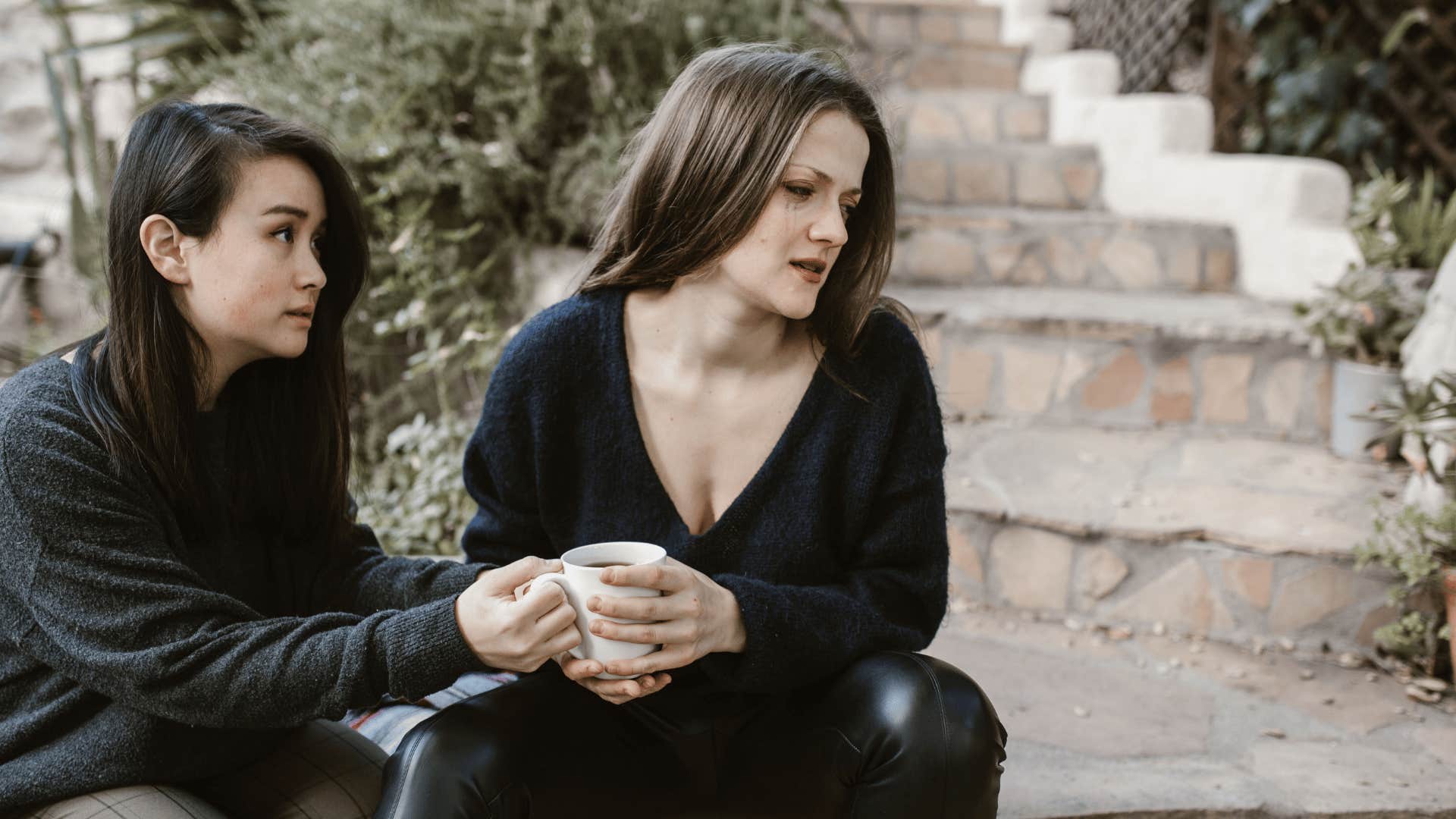 woman comforting upset friend who feels helpless