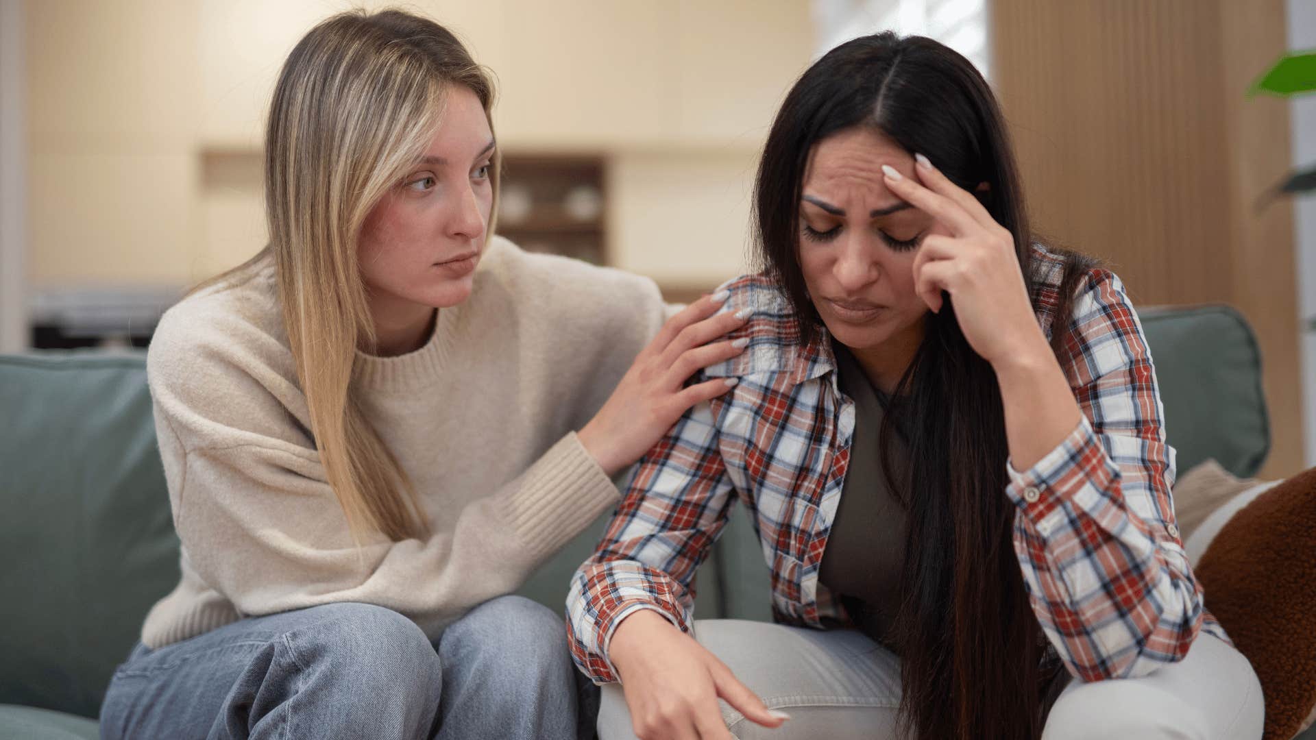 woman comforting friend who is losing hope