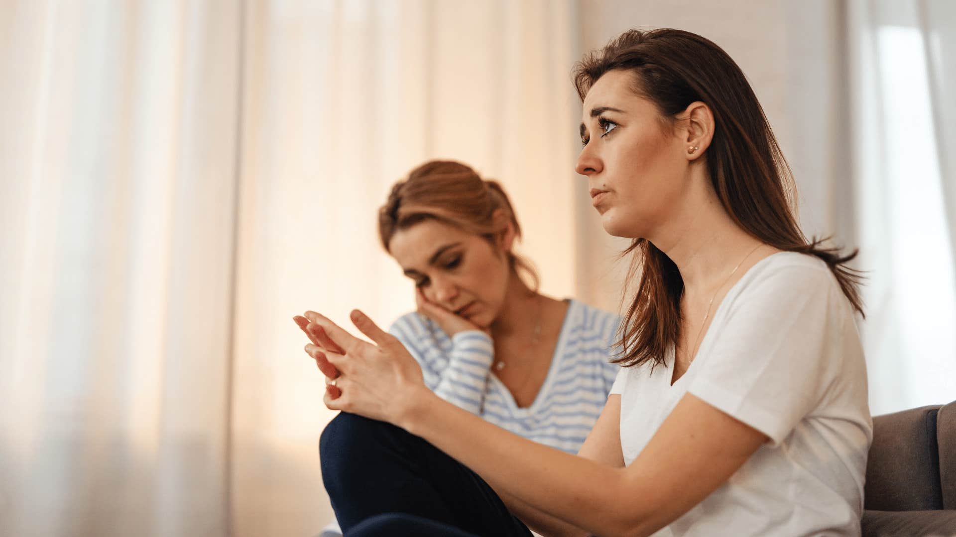 uncertain woman asking friend what to do about bad news