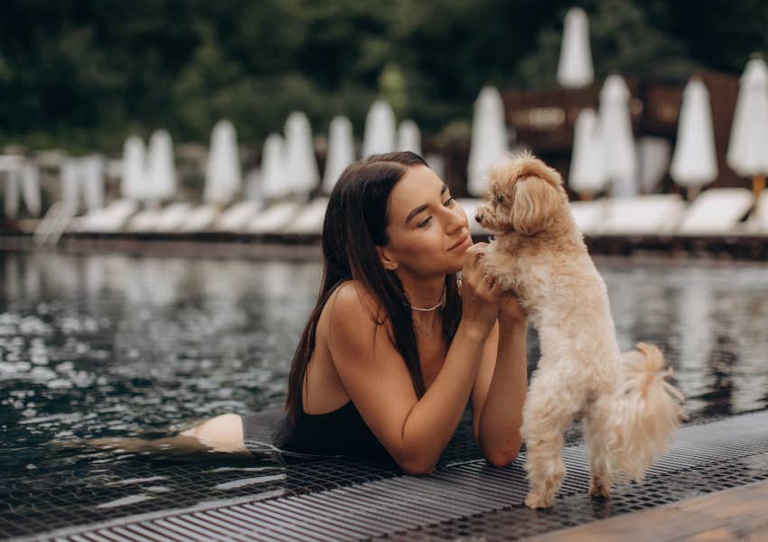 woman brings her dog to a hotel pool