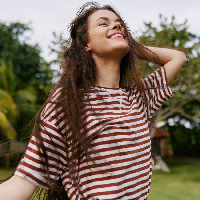 happy, peaceful woman walking outside as a quiet hobby