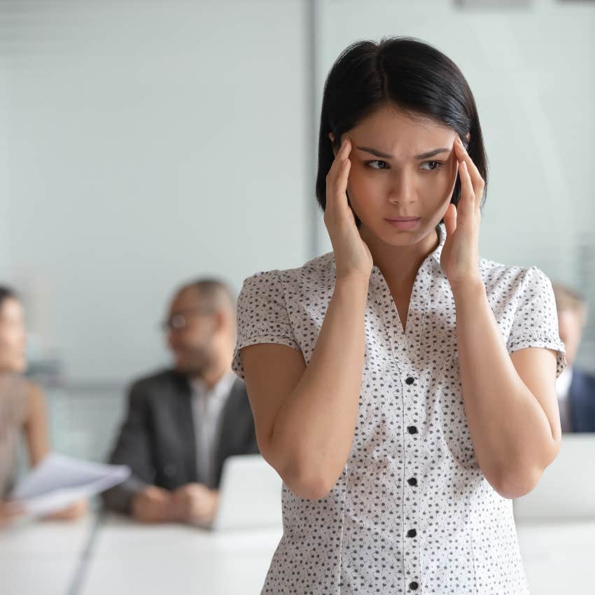 stressed worker feeling pressured by colleagues to overshare her life