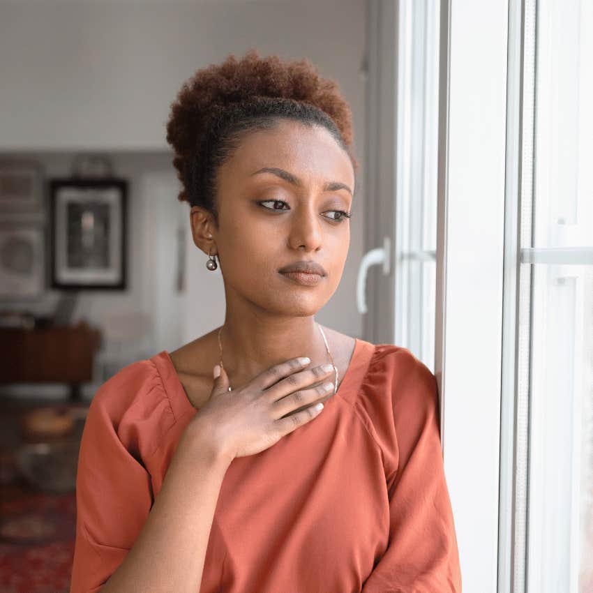 serious woman looking out of window
