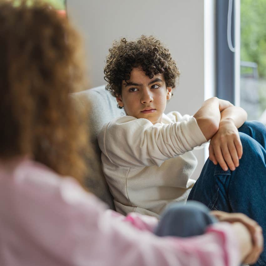 young boy learning conflict-resolution skills in disagreement with parent