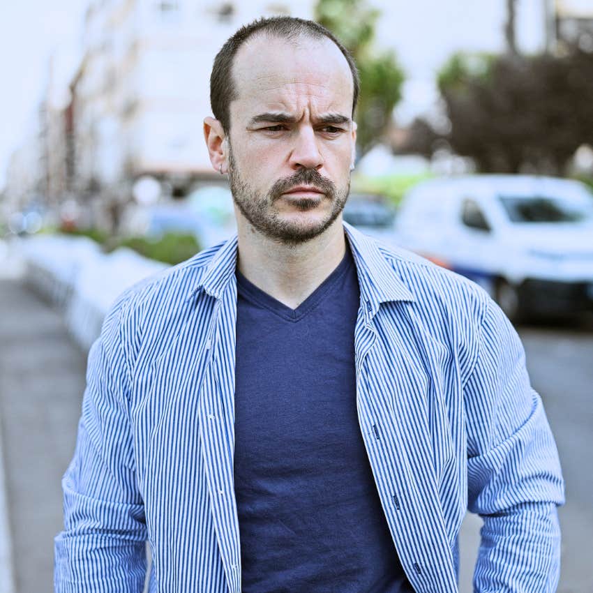 socially anxious man crossing a busy street in public
