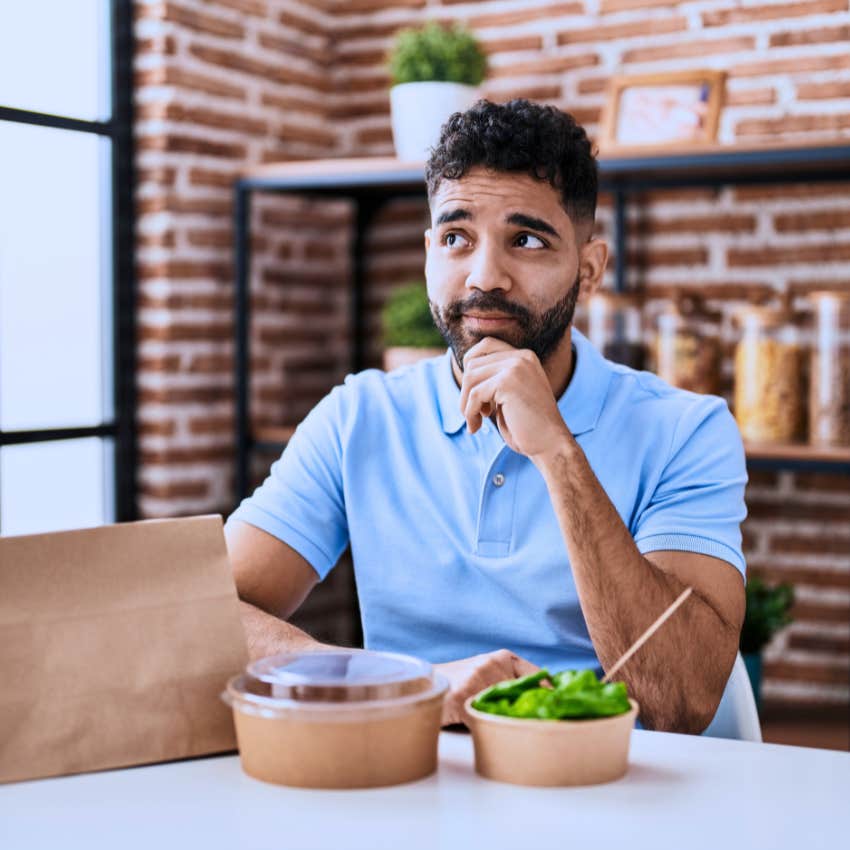 anxious man worried about eating in public restaurant