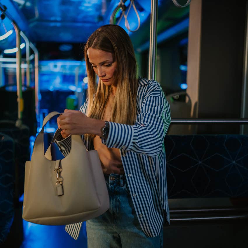 gen x woman digging though large purse looking for checkbook