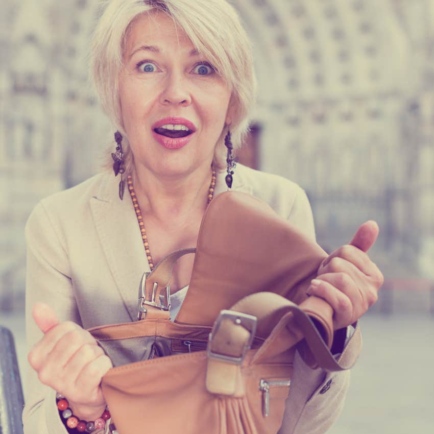 gen x woman startled by how much stuff is in her purse including an in-case-of-emergency contact card
