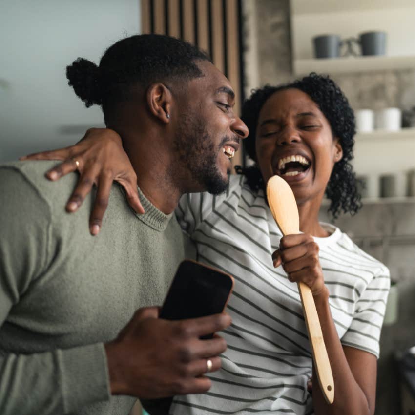 happy couple singing and having fun laughing together