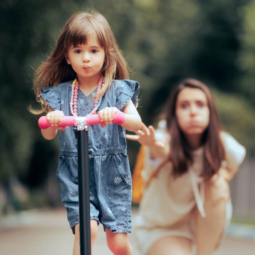 exceptional mom pushing her daughter on scooter to help her be independent