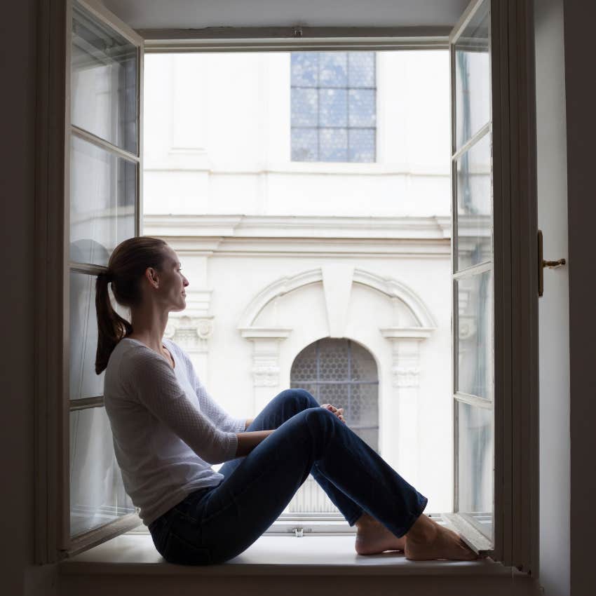 introvert woman enjoying a long stretch of silence sitting on window seat