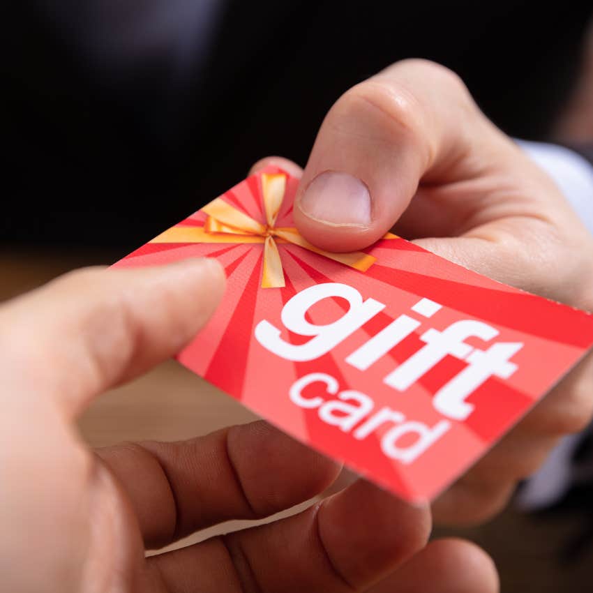 man giving someone a gift card