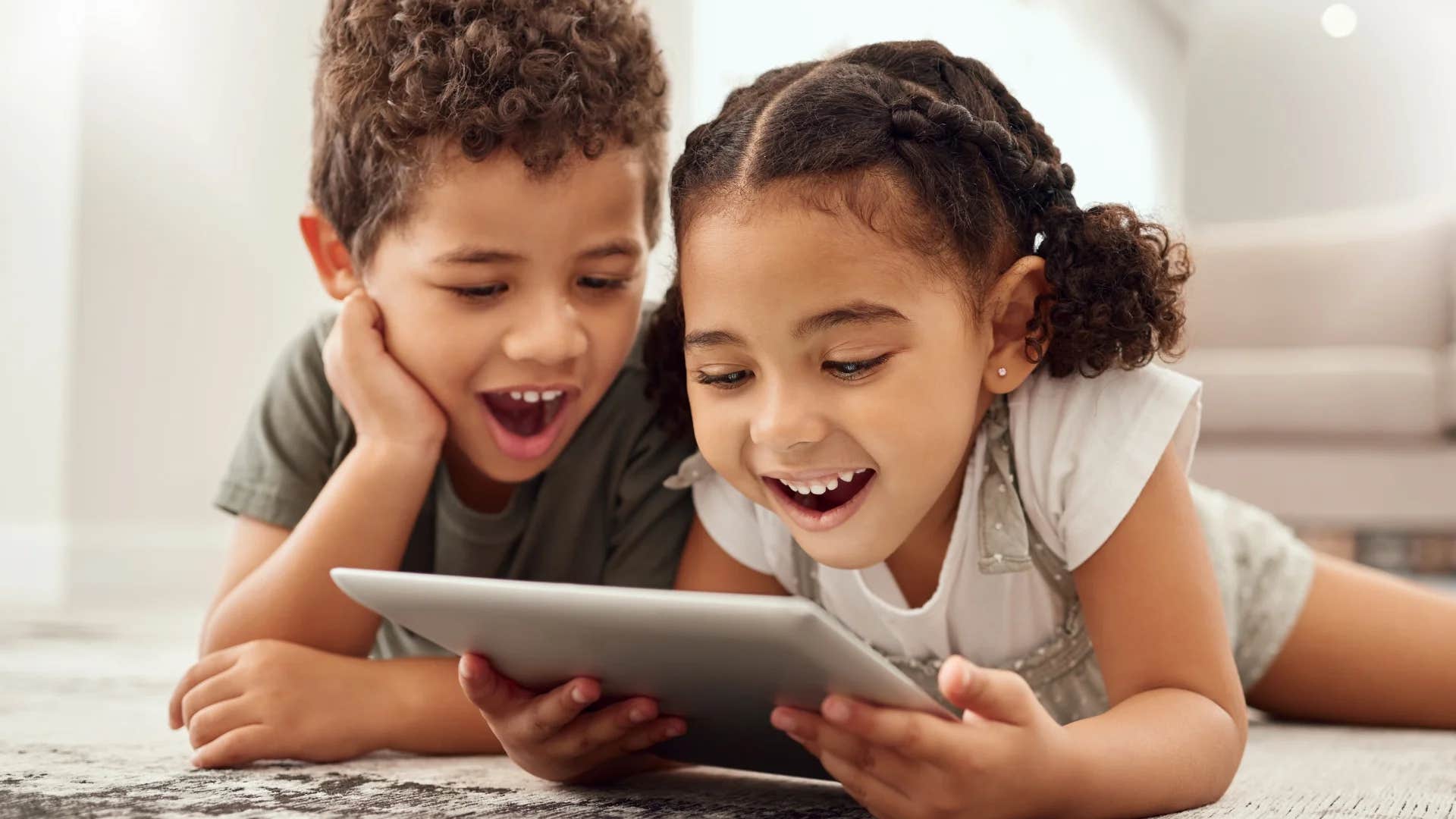young siblings using the ipad at home