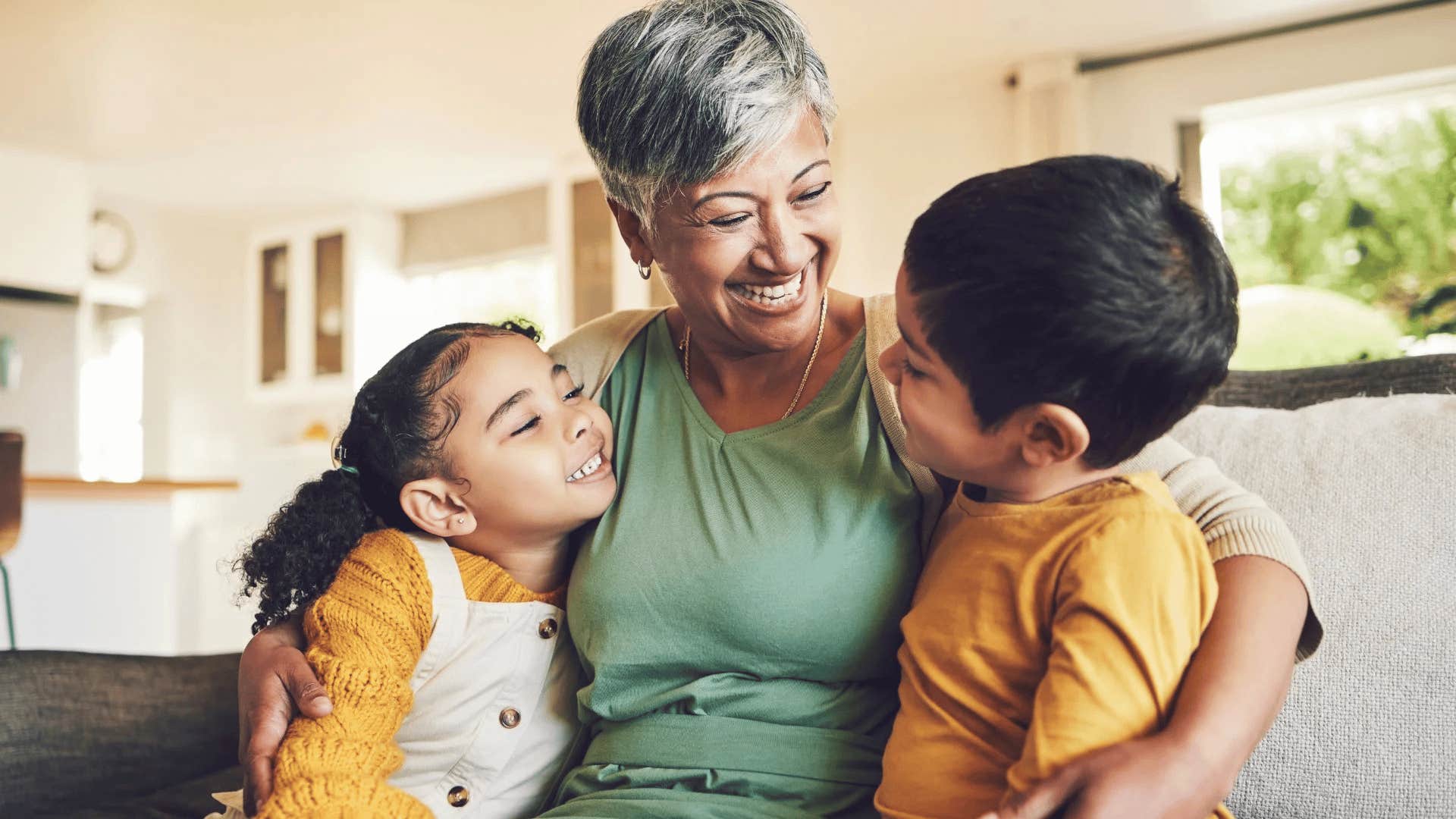 loving grandmother listening to her grandkids speak