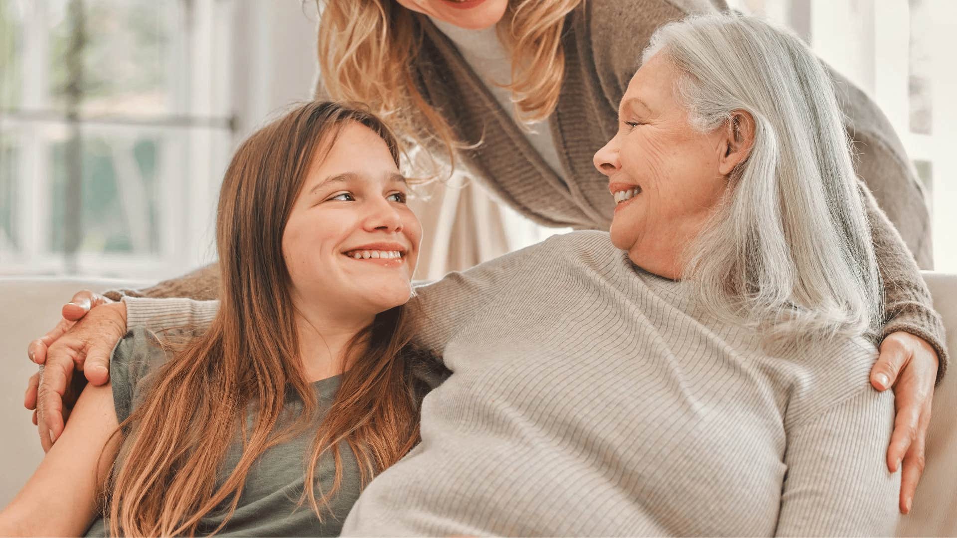 young woman leaning on her supportive grandmother