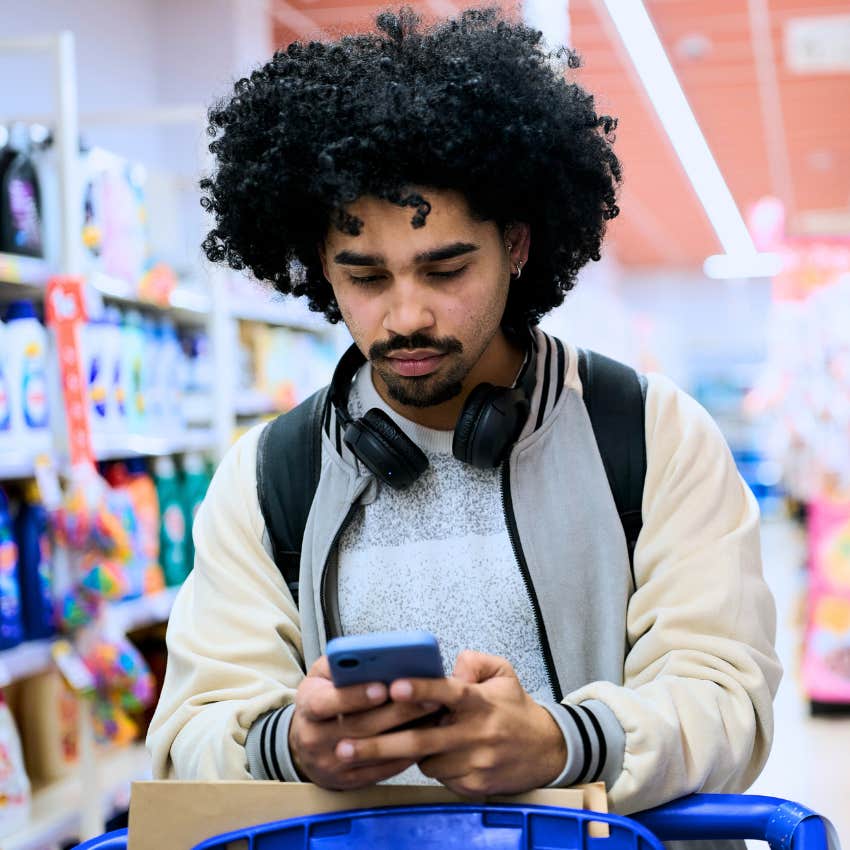 lonely man wearing headphones in the grocery store